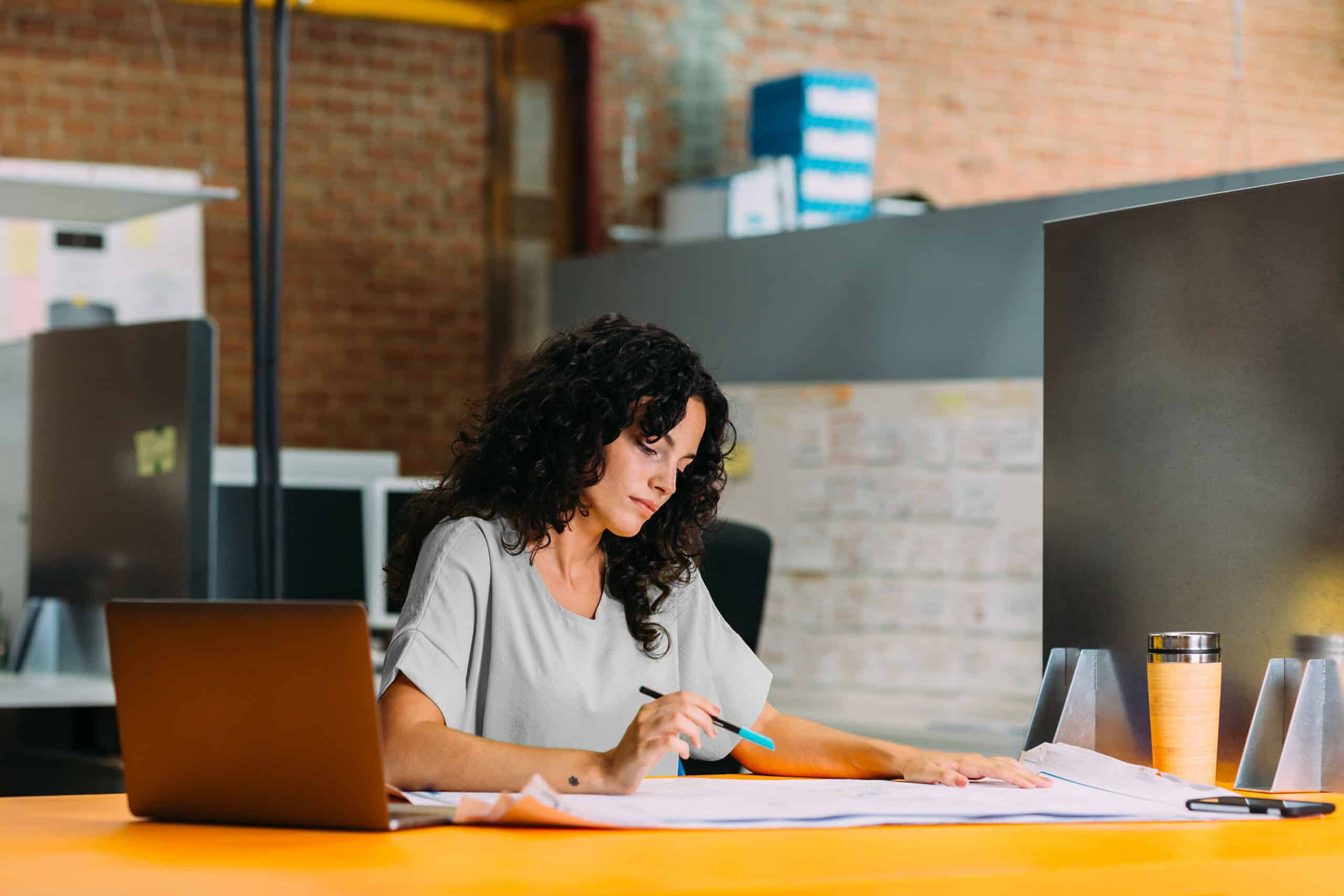 Person looking at papers on desk