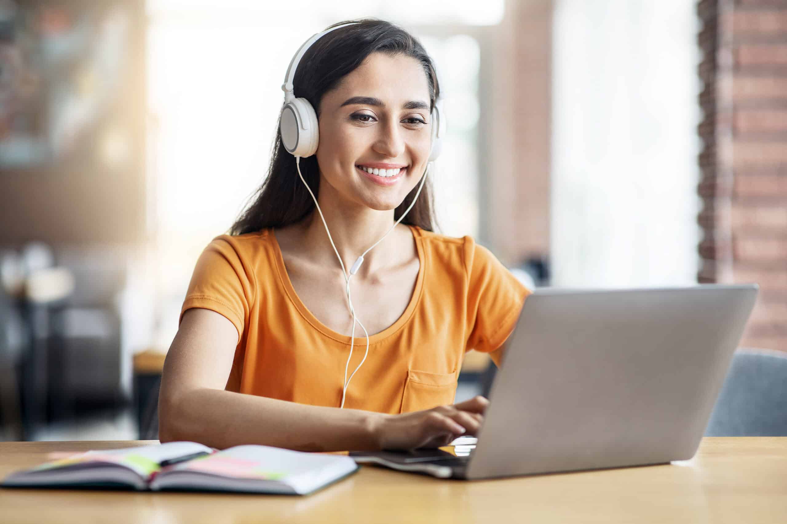 Person with headphones in front of laptop
