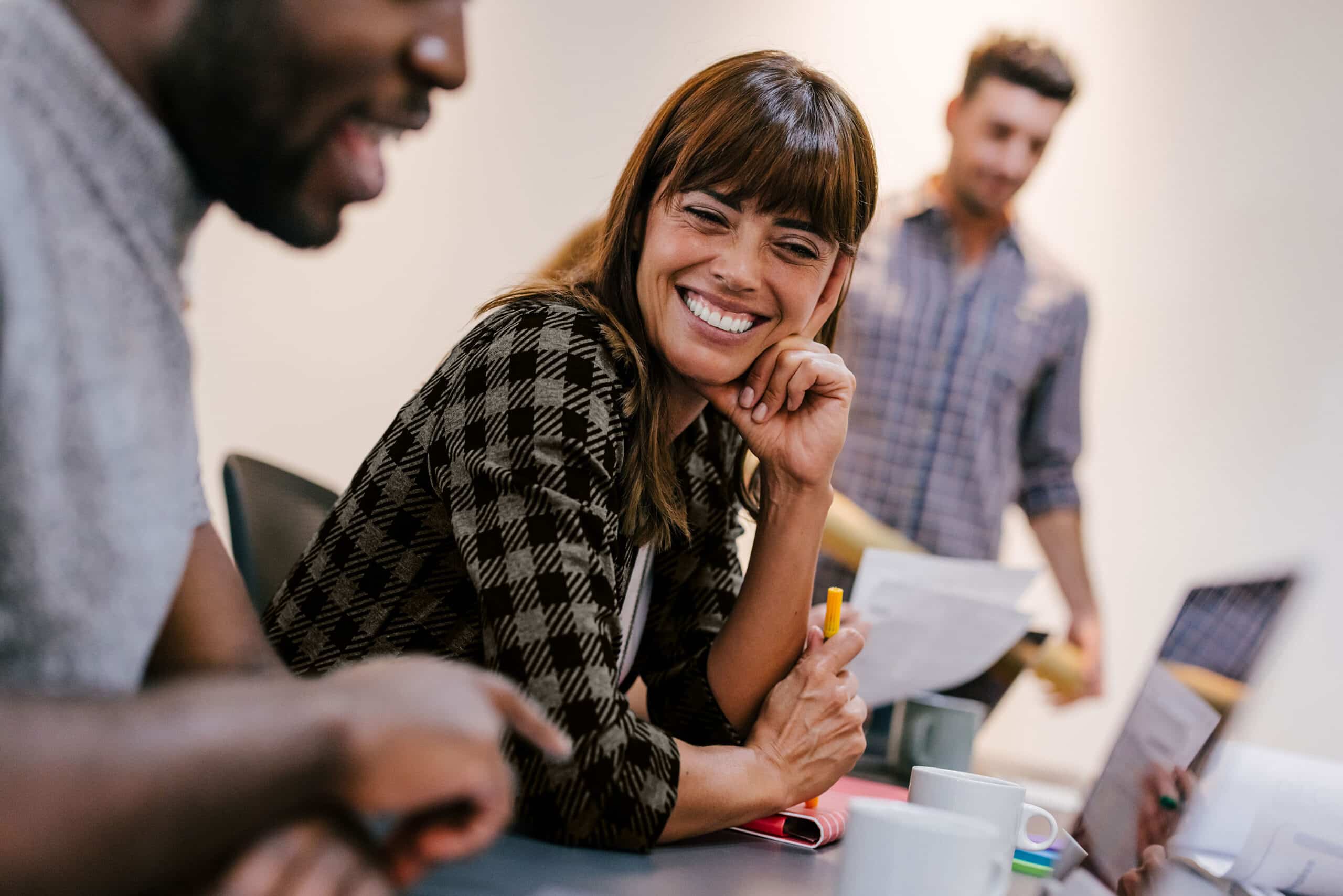 Woman smiling and looking at laptop