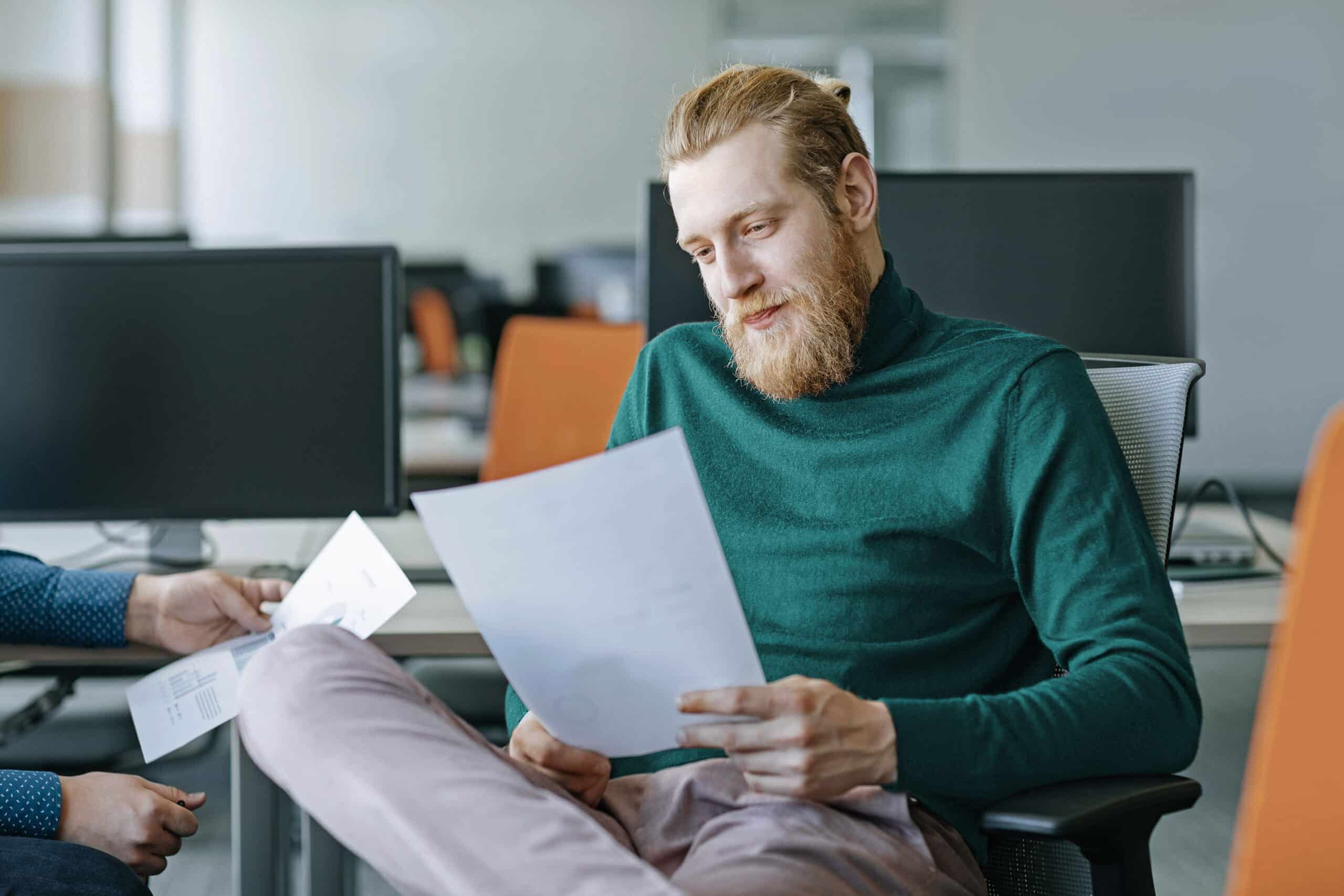 Person looking at piece of paper in office setting