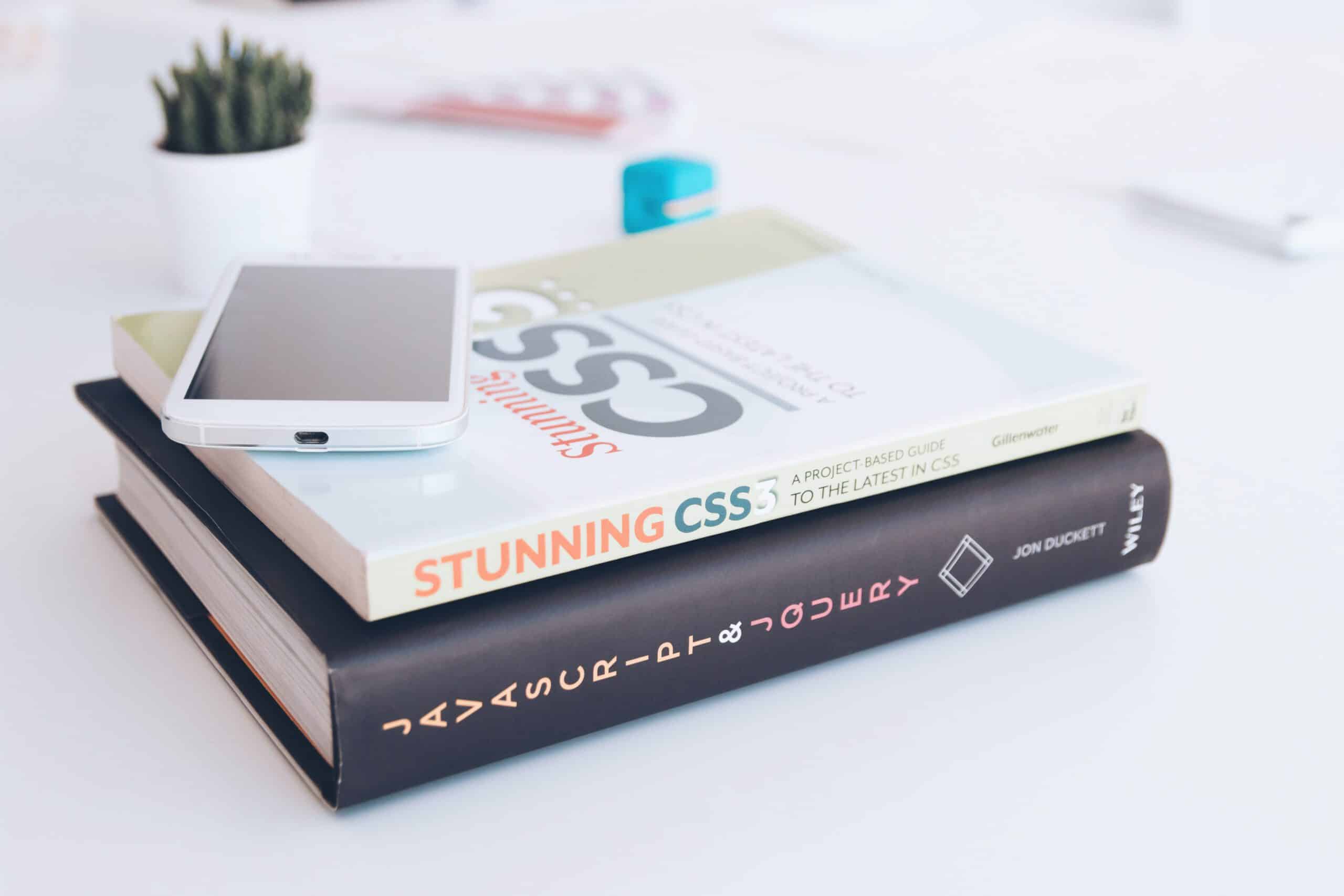 smartphone on two books about javascript and css