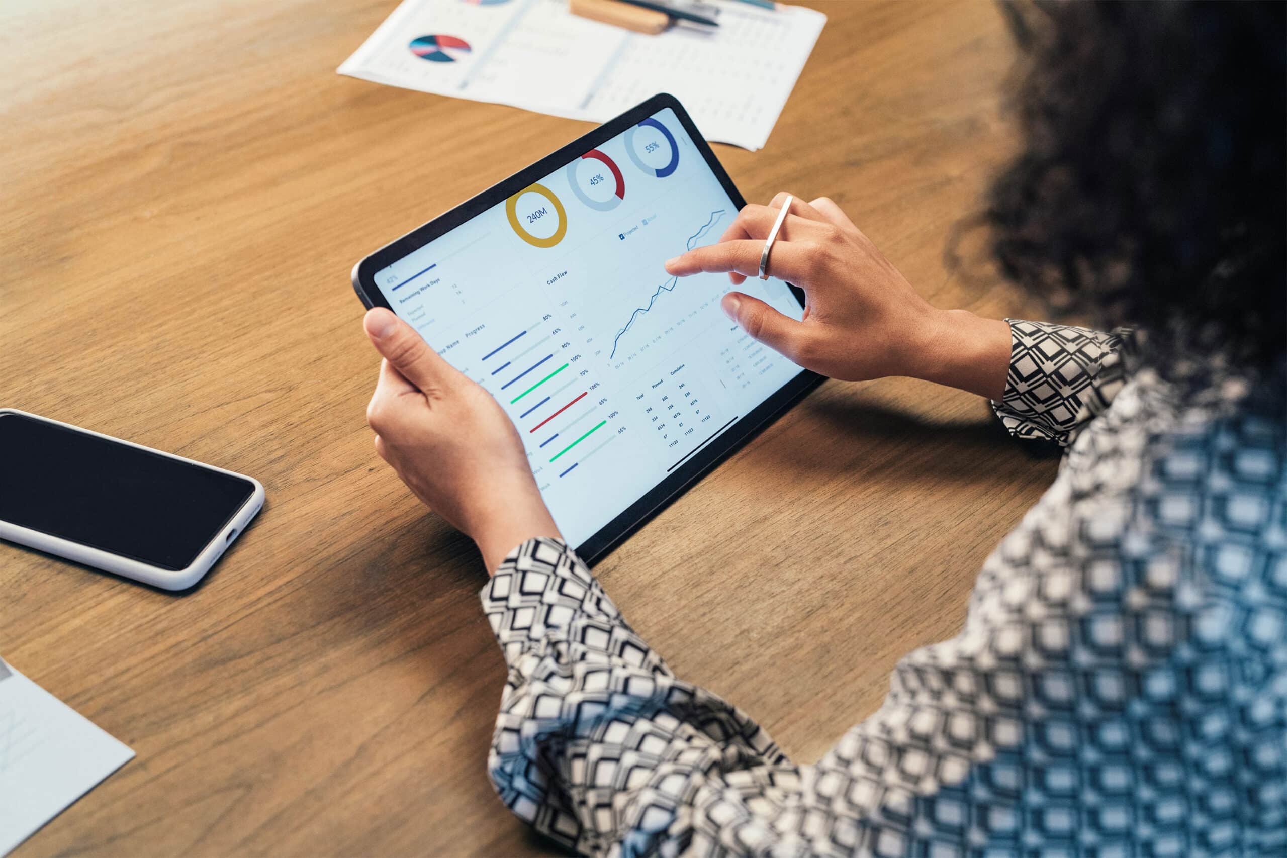 Person looking at graphs and dashboards on tablet