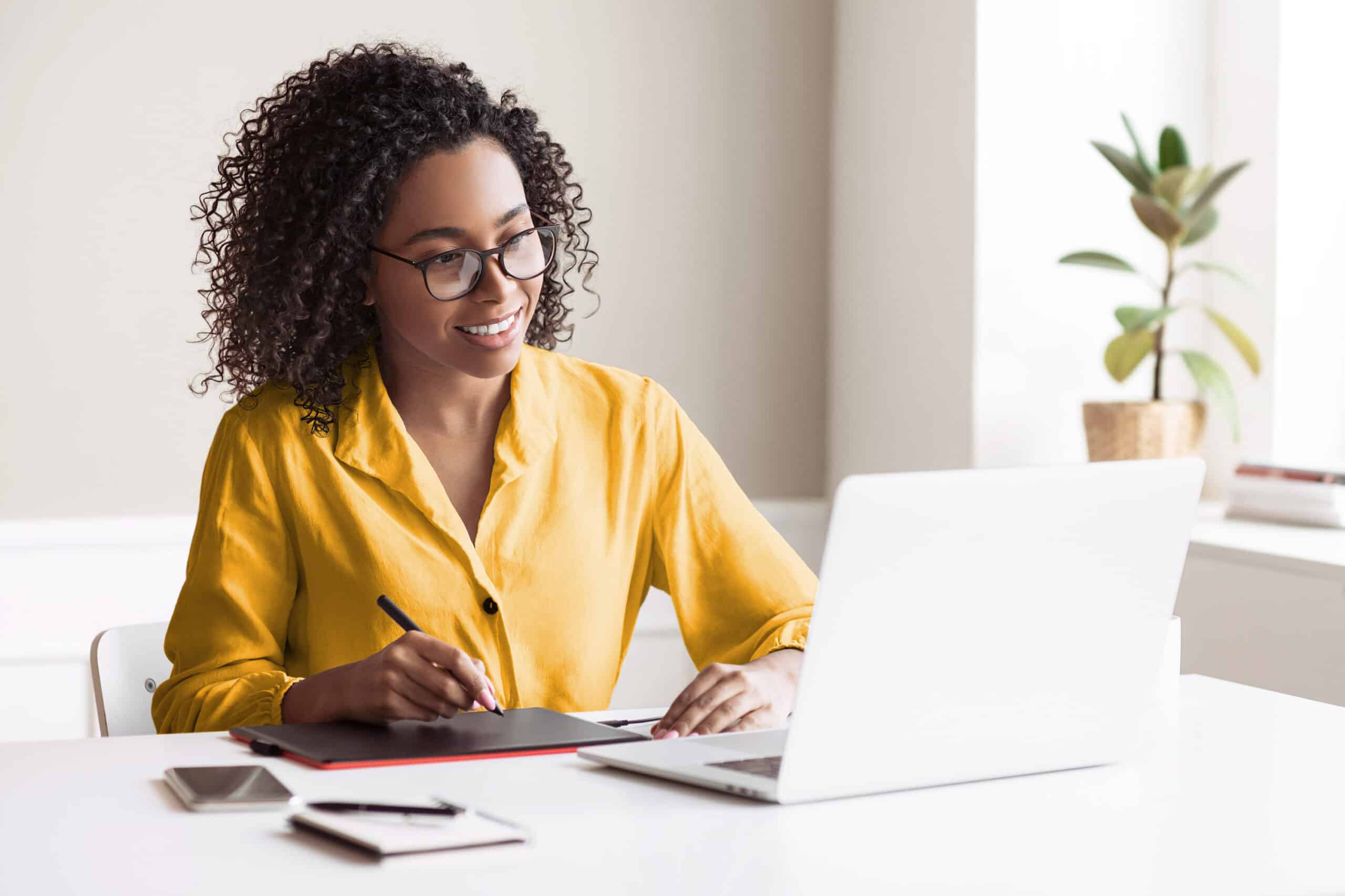 Person at desk in front of laptop