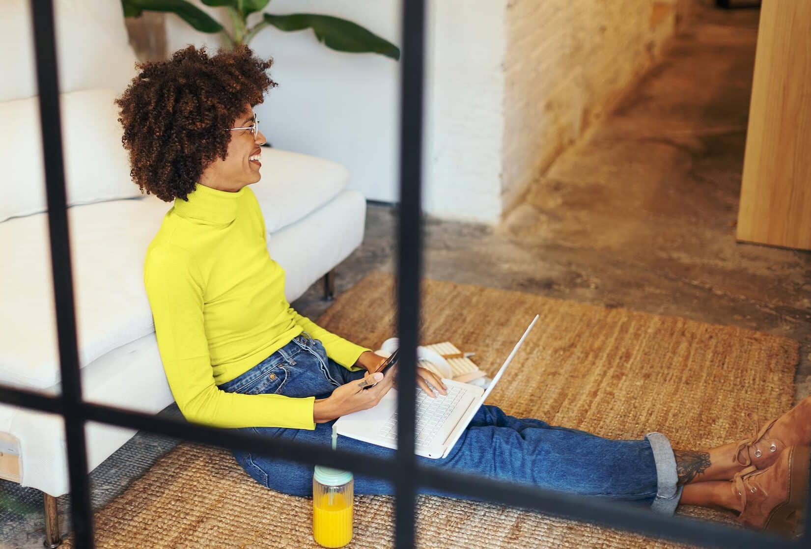 Women in living room participating in online meeting. Udemy Business